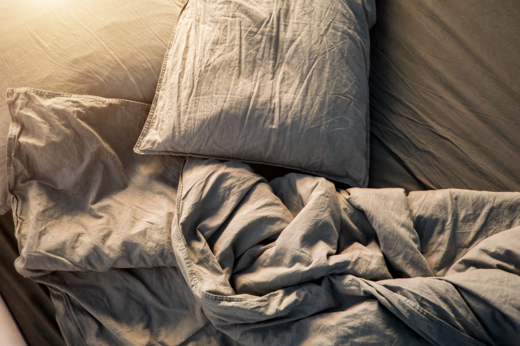 Blue bed sheets and pillows after night's sleep.