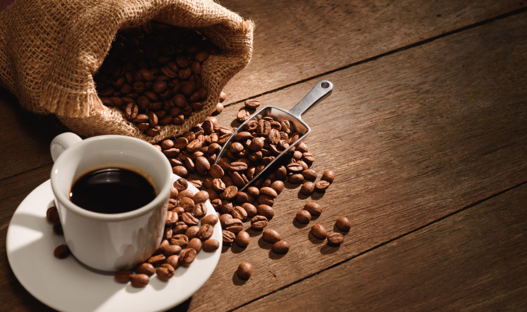 A shot of espresso with roasted coffee bean