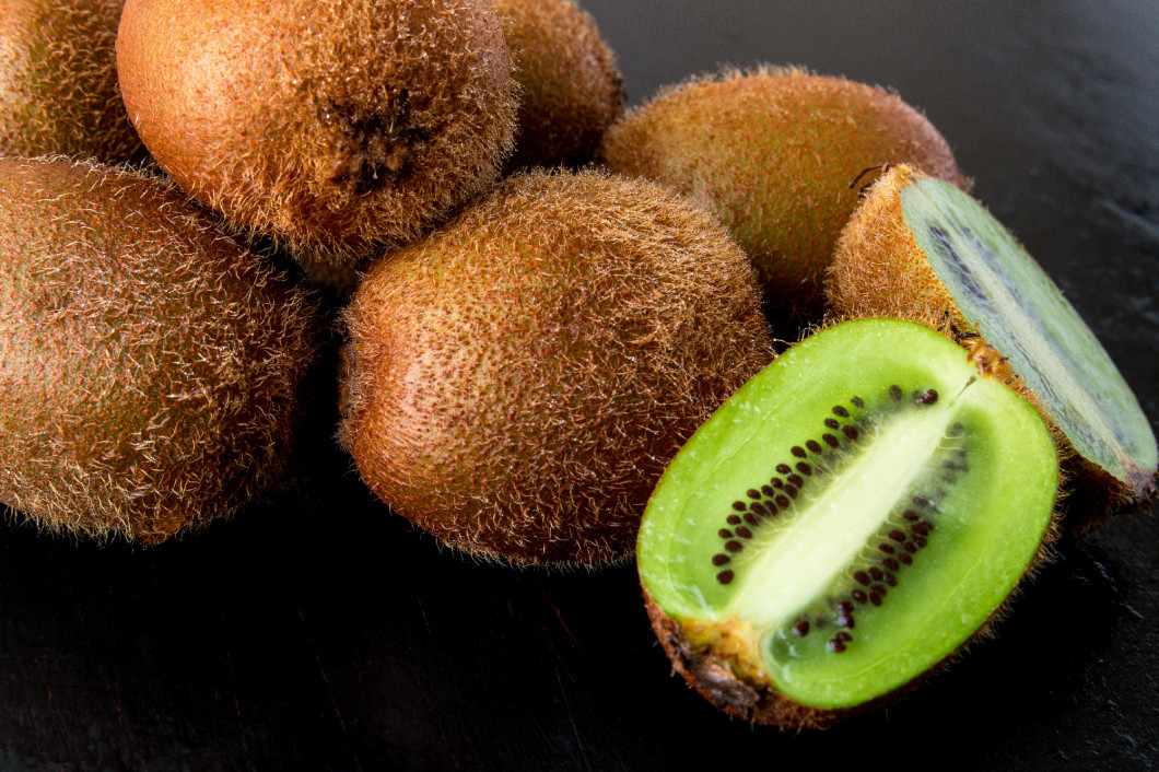 Fresh kiwi on black backround. Close up.