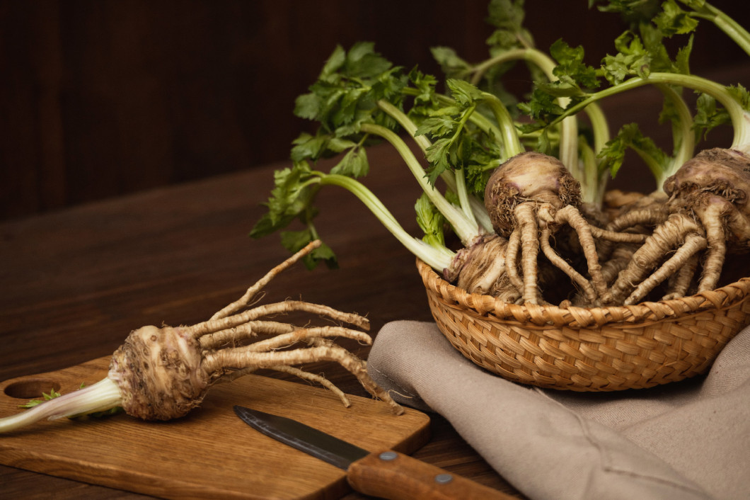 Root celery in a wicker plate on a cloth napkin on a wooden back