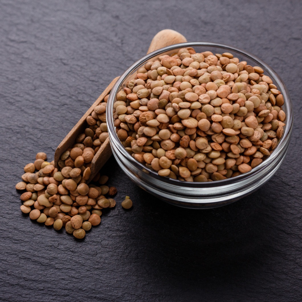 raw lentils on a dark stone background