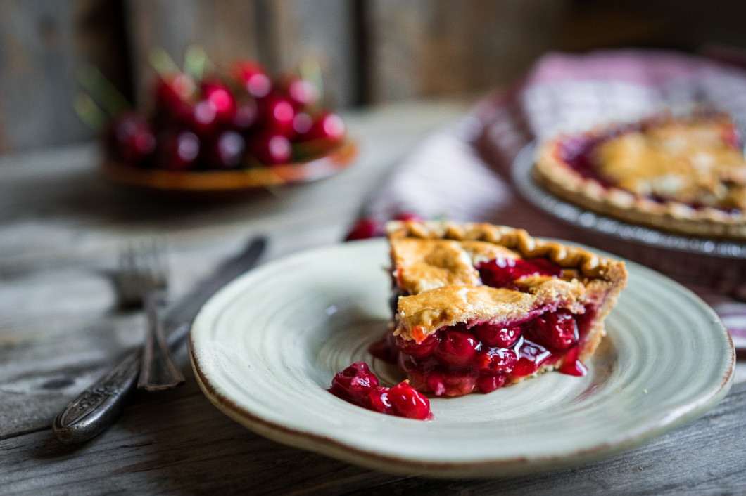 Homemade cherry pie on rustic background