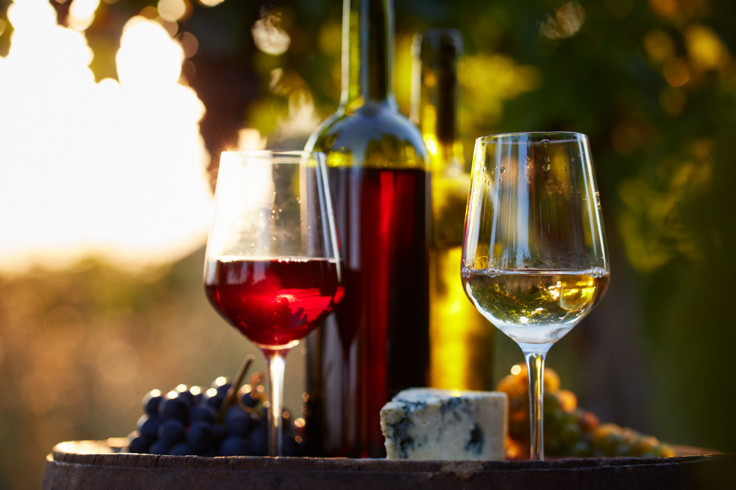 Two glasses of white and red wine at sunset