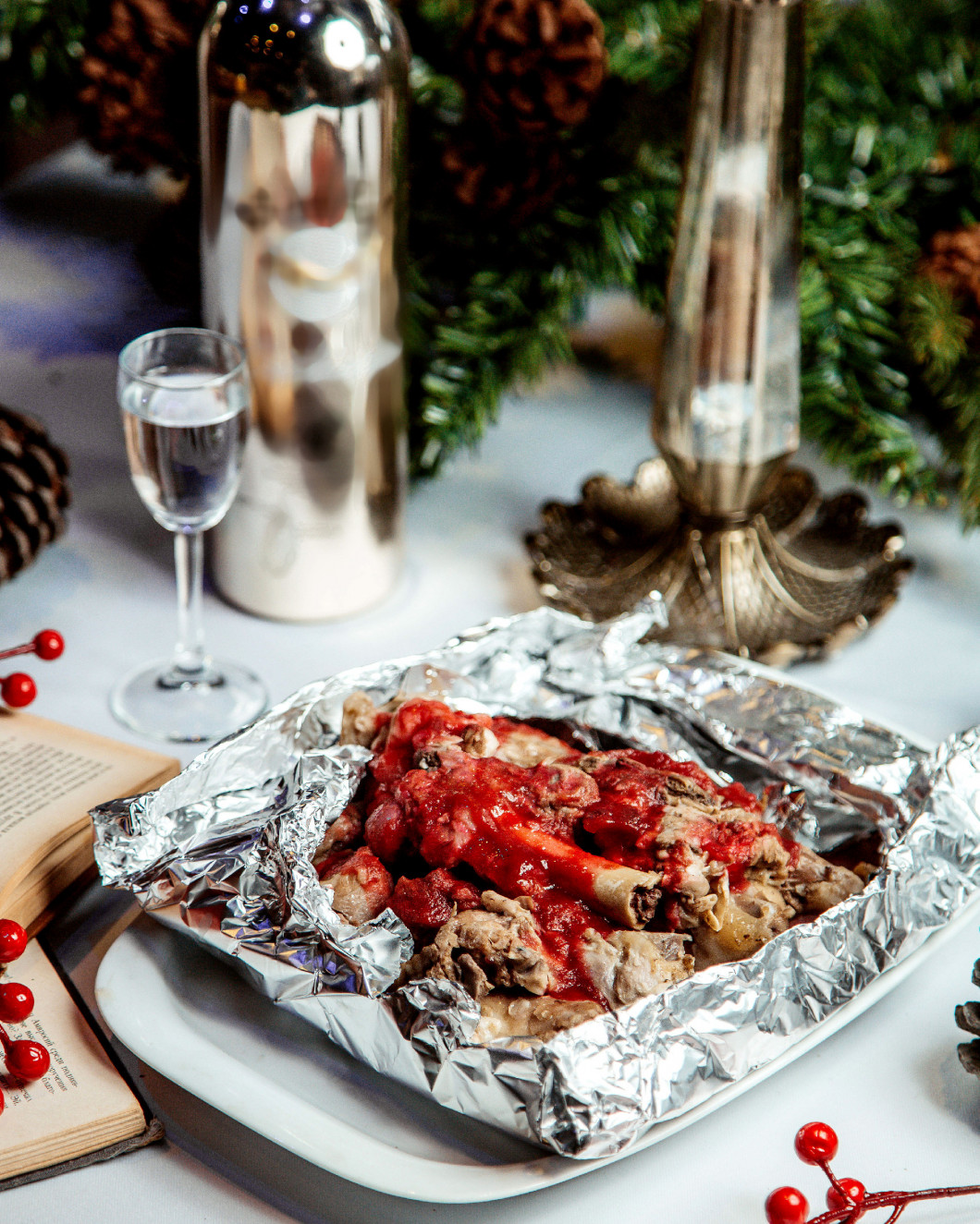 meat pieces with sauce and glass of vodka