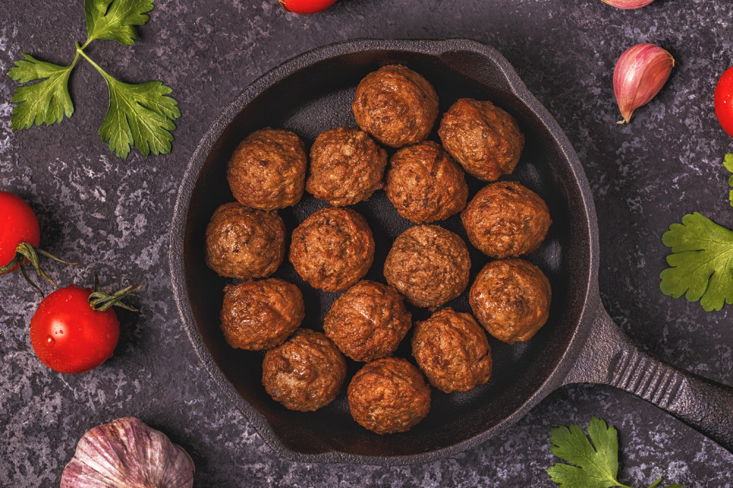 Roasted  meatballs with tomatoes, garlic and parsley.