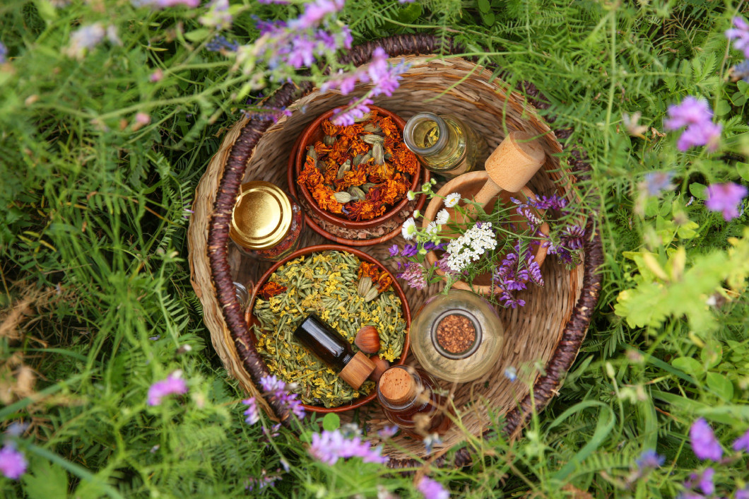 Different ingredients for tincture, mortar and pestle in wicker 