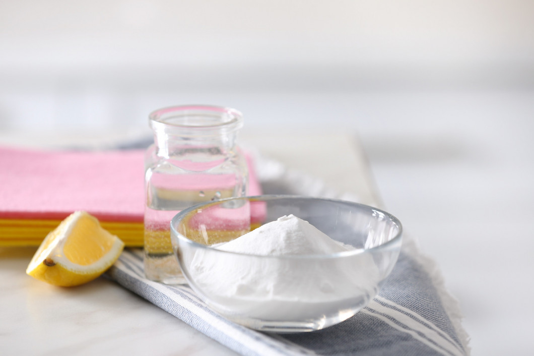 Baking soda, lemon and vinegar on white marble table. Eco friend